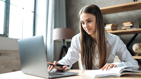 caucasian female student is studying in college remotely