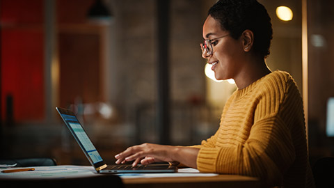 A person reading information on a laptop