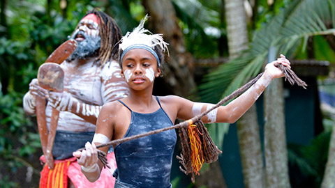 Young adult Indigenous Australian Aboriginal woman dancing to the singing rhythm sound of Australian Aboriginal