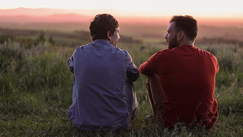 A health worker chatting to a client in an outdoor environment