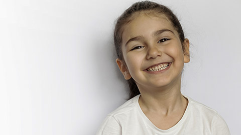 Portrait of happy smiling child girl isolated on white background