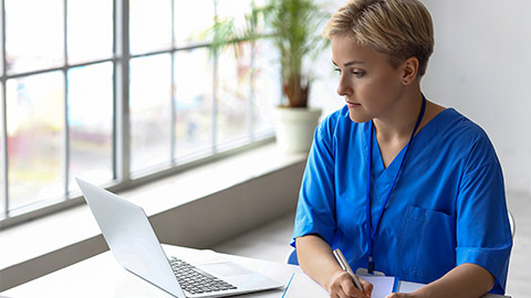 Female medical intern working at reception in clinic