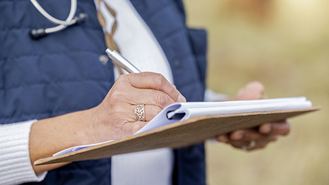 Veterinarian, farm or hands writing a checklist to monitor medical wellness or agriculture on field