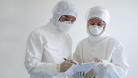 doctor and nurse are wearing PPE and looking for corona/covid-19 virus infected patient's laboratory report