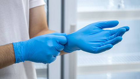 Doctor wearing blue nitrile gloves