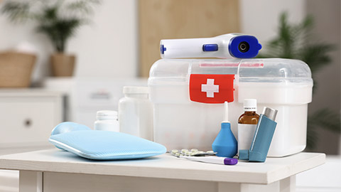 Home first aid kit with medical supplies on table in bathroom, closeup