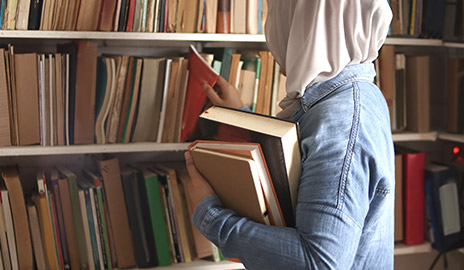 a muslim girl taking more books