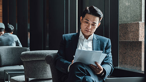 A lawyer reading materials in an office