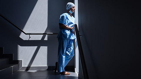 A healthcare worker standing alone