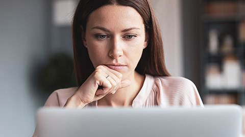 A close view of a person reading from a laptop