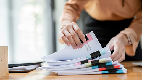 A pile of paperwork on a desk