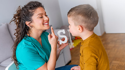 A speech therapist with a child