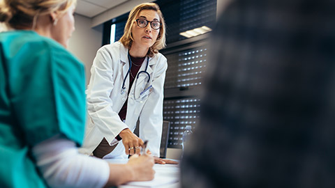 Doctor talking to care and client