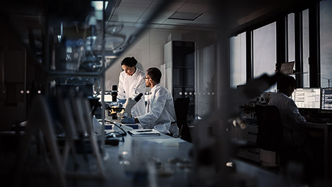 A female medical researcher talking to a colleague