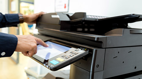 A person using an office printer