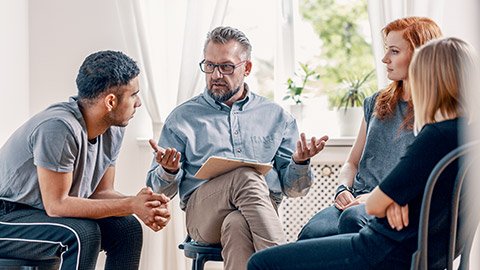 Counselor talking to his group of clients