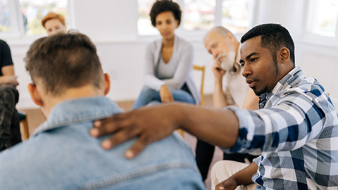 Closeup back view of unrecognizable sad man sharing life problemsin modern mental health support group session