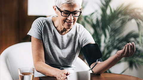 A senior person checking their blood pressure at home