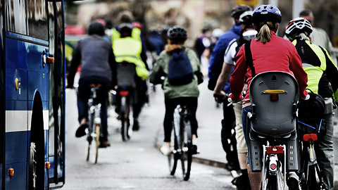 A crowd cycling to destinations on city roads