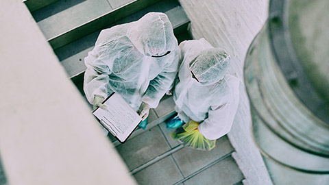 Top down view of 2 people in full PPE