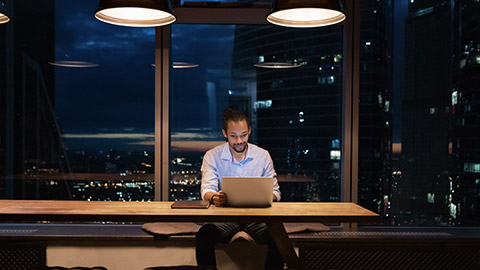 A wide shot of a person reading in an office