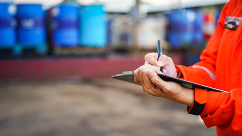 A person writing on a clipboard