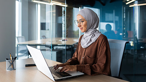 A person typing on a laptop