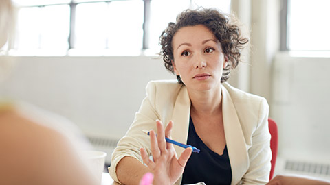 A person talking sternly to a colleague