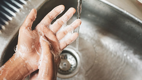 A close view of a person washing their hands