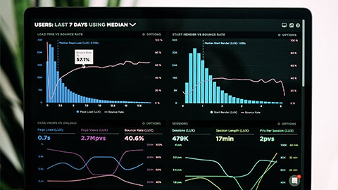 A close up of a Digital Marketer's laptop, displaying an analytics dashbaord of site traffic