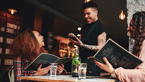 A waiter interacting with customers