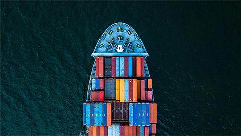 A large ship cutting through a choppy sea