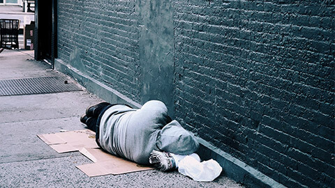 A homeless person sleeping on the street