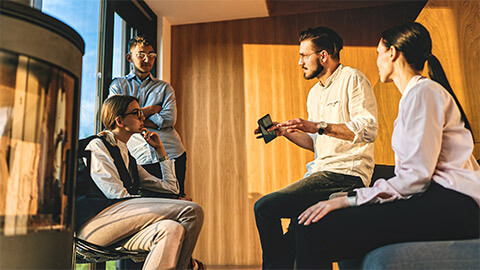 A small team holding a planning session in a sun-drenched meeting room