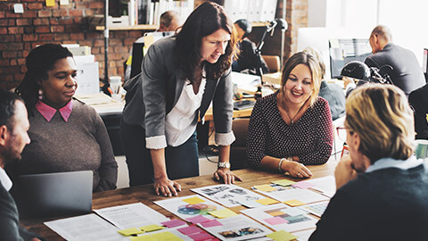 A marketing group sitting around a table discussing a marketing plan