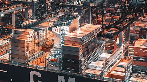 A close view of a container ship loading up for international transport of goods