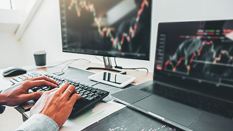 A close view of a business person checking stock market conditions on a desktop computer