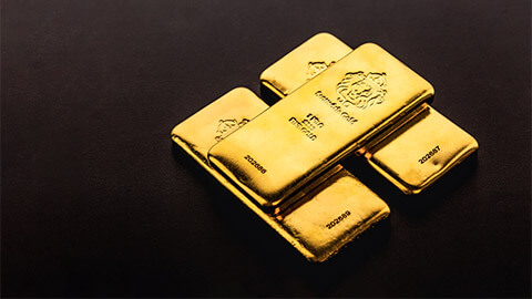 Three, one kilogram bars of gold neatl stacked