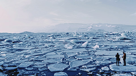 2 people standing on floating ice in a polar region