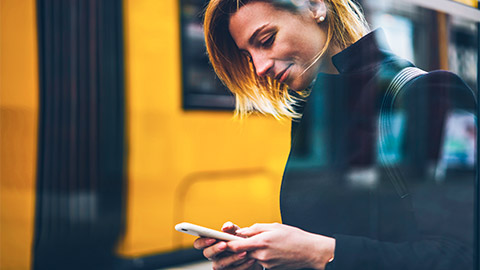 A commuter communicating on their smart phone, prior to catching the train home