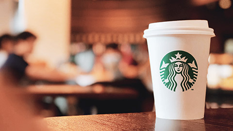 A close view of a Starbucks take away cup