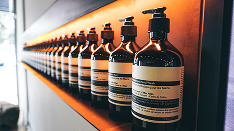 A row of Aesop Hand Wash in a retail space