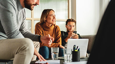 A group of young professionals discussing a project