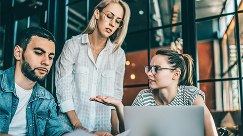 Three colleagues holding a meeting, disagreeing over a work matter