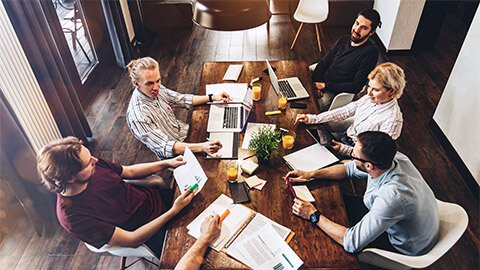 Executives holding a meeting, reviewing their organisation's position in the market