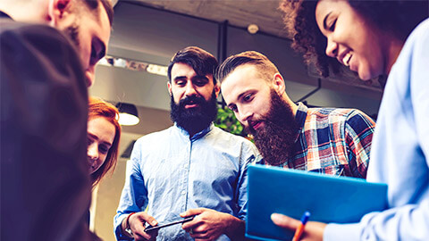 A small group of entrepreneurs holding a meeting after recently launching their startup