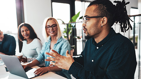 A diverse group of busienss professionals discussing a project