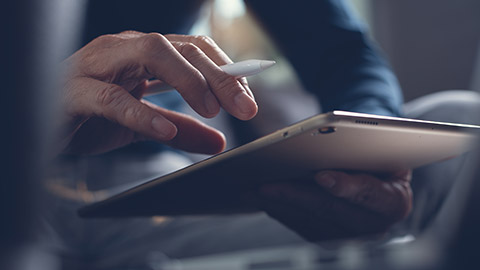 A close view of a person typing on a tablet device