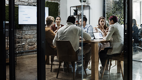 A group of sales employees in a group meeting