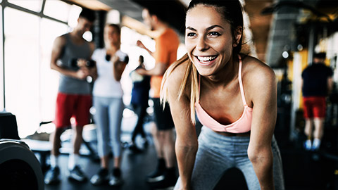 Close up image of attractive fit woman in gym